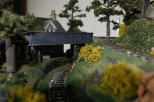 house near model railroad tracks
